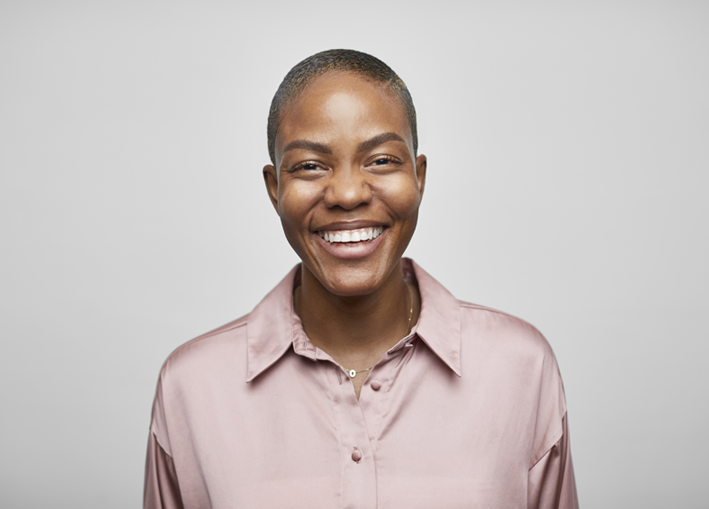 Photo of a middle aged person smiling happily while looking ahead