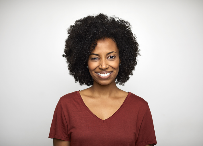 Photo of middle aged woman smiling while looking ahead