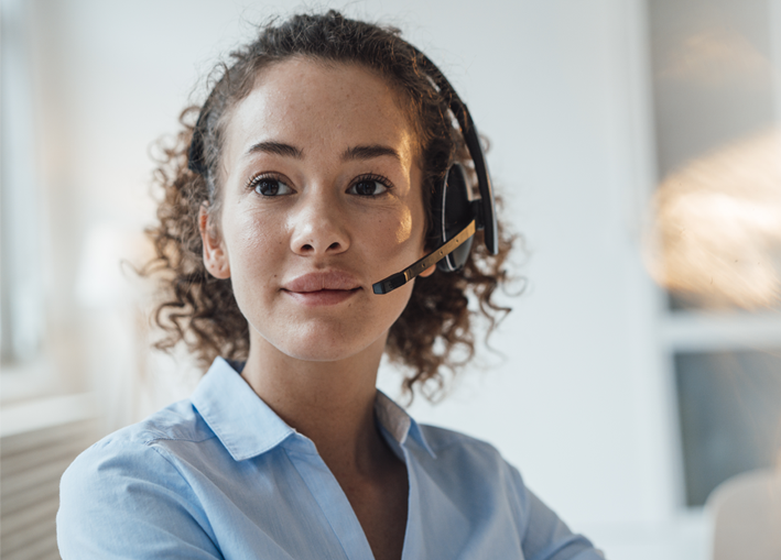 Photo of woman on headset listening to member