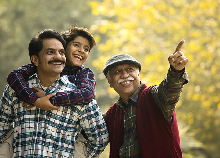 Photo of grandfather, father, and son out enjoying nature together