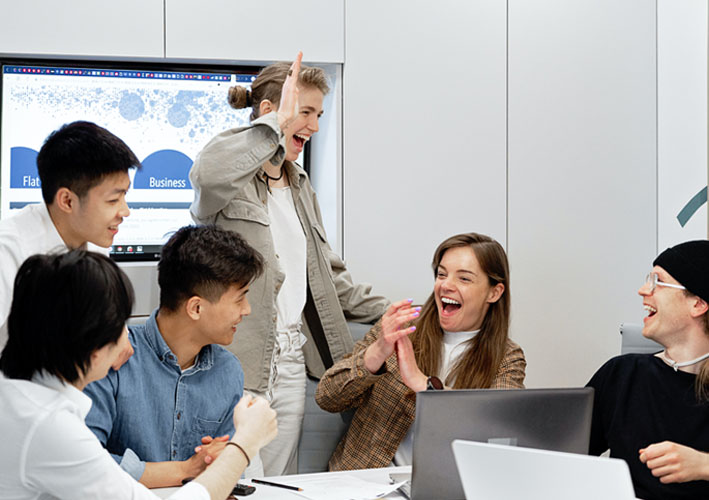 Photo of business people in office celebrating