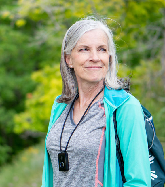 Photo of woman wearing PERS exploring nature