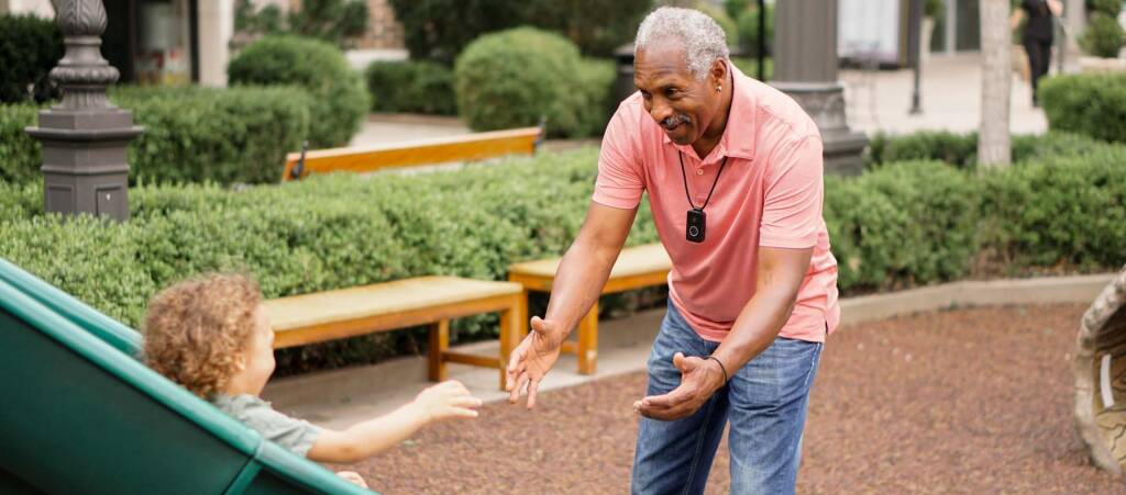 Photo of grandfather with grandson at the park